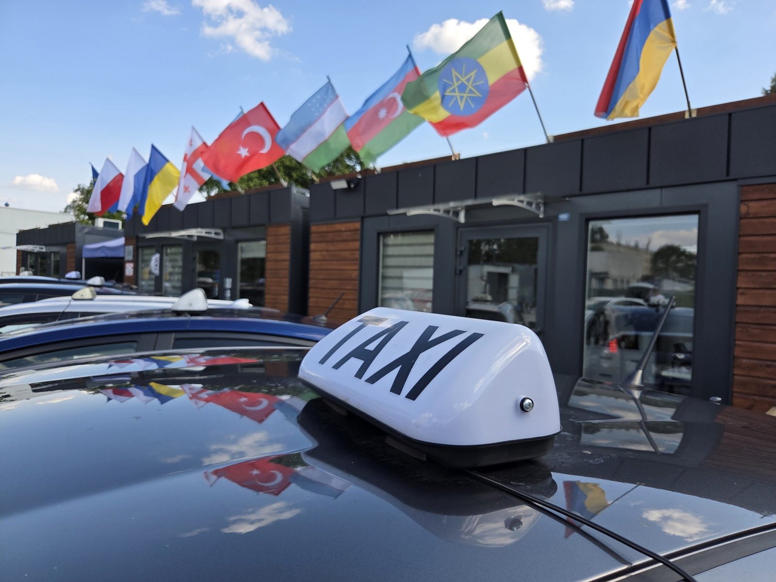 Taxi driver reviewing digital billing report with Agora Partner in Poland